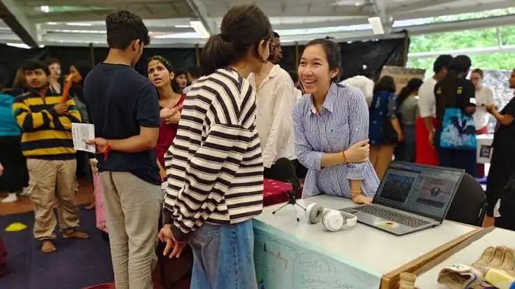 Students talking over laptops at a campus event